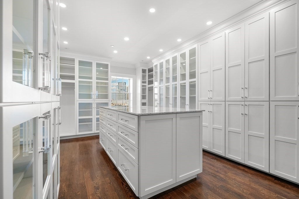 63 Mount Vernon ample closet space with white and clear cabinets, and center storage island. 