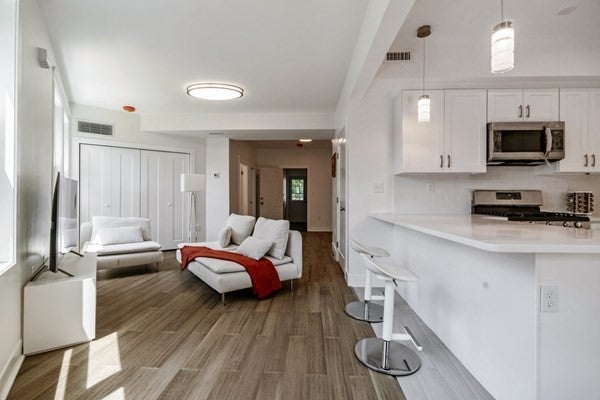 82 Ballou Ave living and kitchen space, both room that are open to each other has hardwood flooring.