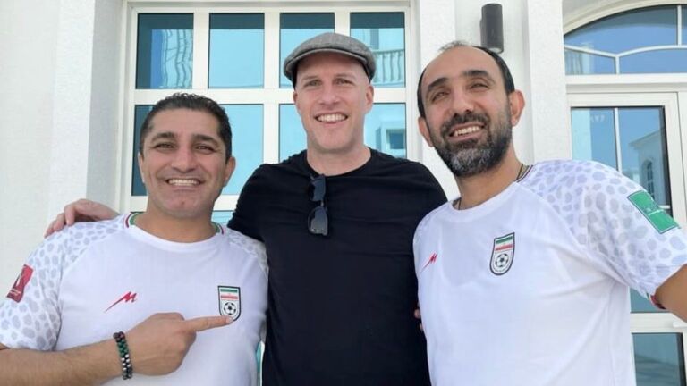 Grant Wahl (center) poses with two Iranian soccer fans early in the 2022 World Cup in Qatar.
