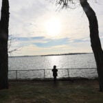 People stroll through Lynch Park in Beverly.