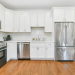 248 Amory, Unit 2 kitchen with white cabinets and stainless steel appliances.
