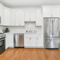 248 Amory, Unit 2 kitchen with white cabinets and stainless steel appliances.