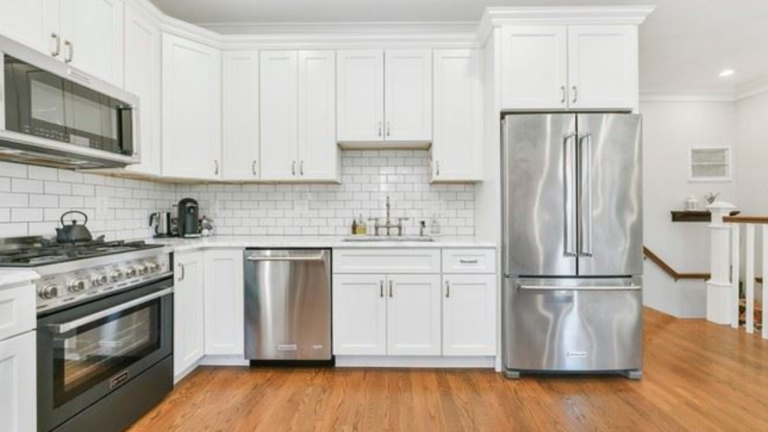 248 Amory, Unit 2 kitchen with white cabinets and stainless steel appliances.