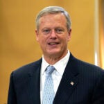 Gov. Charlie Baker speaks with reporters during a news conference Nov. 9 at the State House in Boston.