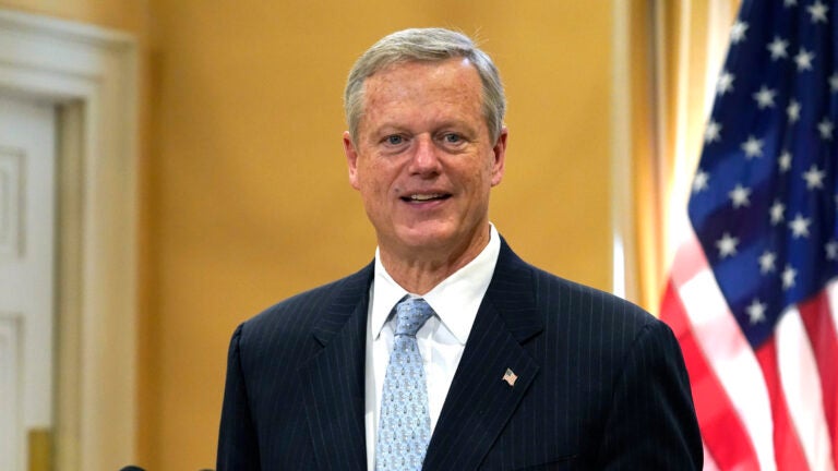 Gov. Charlie Baker speaks with reporters during a news conference Nov. 9 at the State House in Boston.