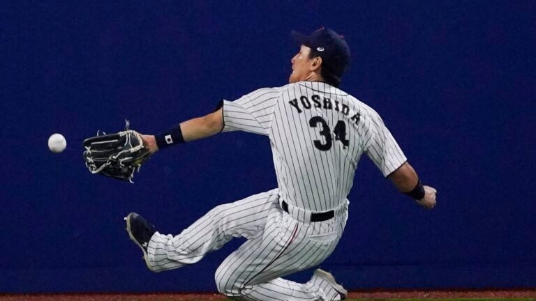 Japanese free agent outfielder Kosuke Fukudome, left, shows his