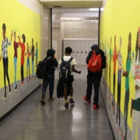 Students walk down a hallway at Jeremiah Burke High School.