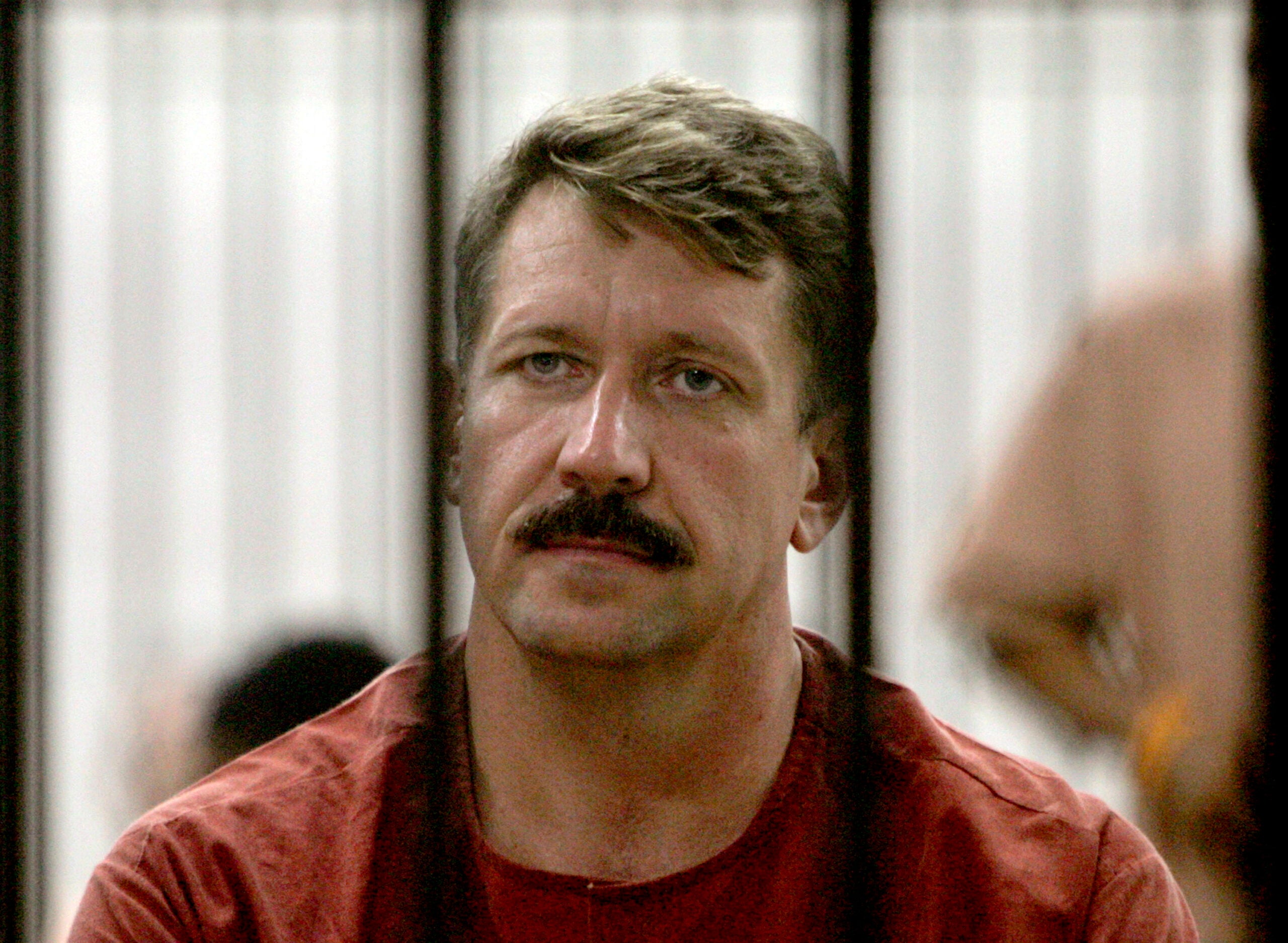 Viktor Bout looks out from inside a detention center while waiting for a hearing on his extradition to the United States on May 19, 2009, in Bangkok, Thailand.