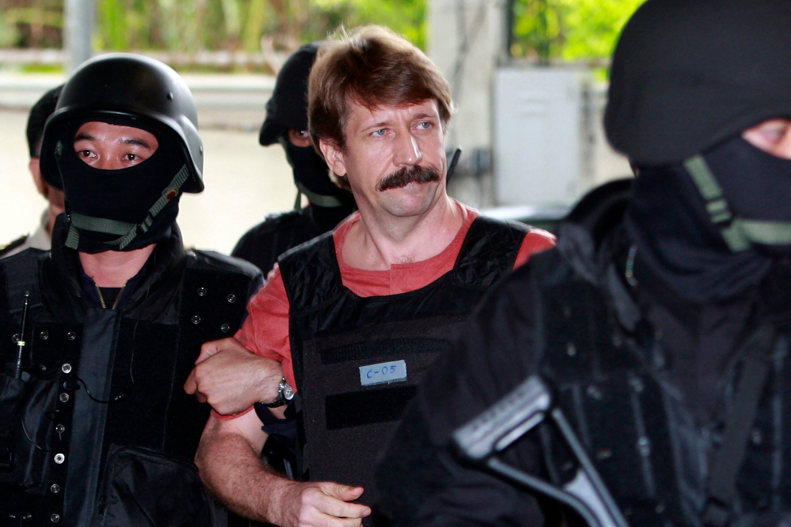 Viktor Bout is led by armed Thai police commandos as he arrives at the criminal court in Bangkok, Thailand, on Oct. 5, 2010.