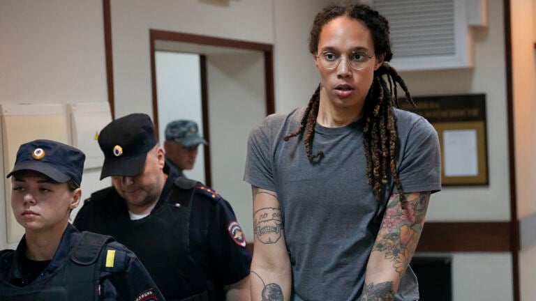 Brittney Griner is escorted from a courtroom after a hearing in Khimki, just outside Moscow, on Aug. 4, 2022.
