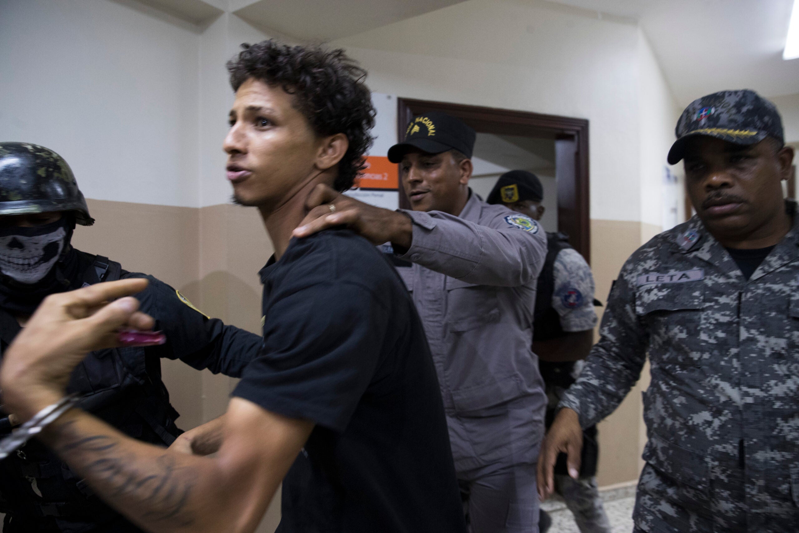 Rolfi Ferreyra Cruz, the alleged shooter, is taken to court by the police in Santo Domingo, Dominican Republic, in June 2019.