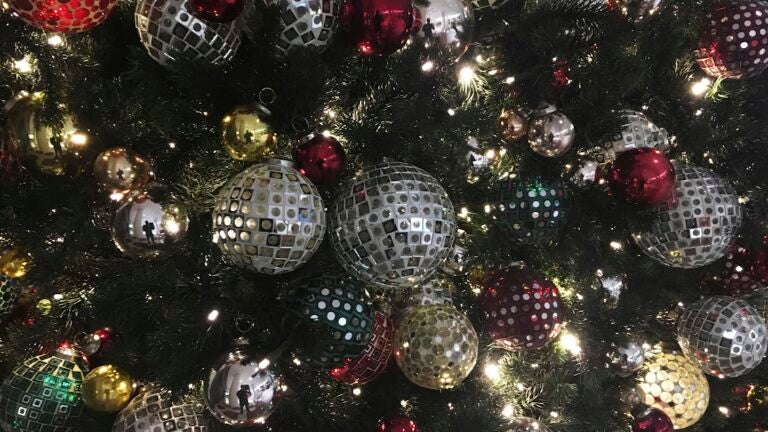ornaments hang on a Christmas tree