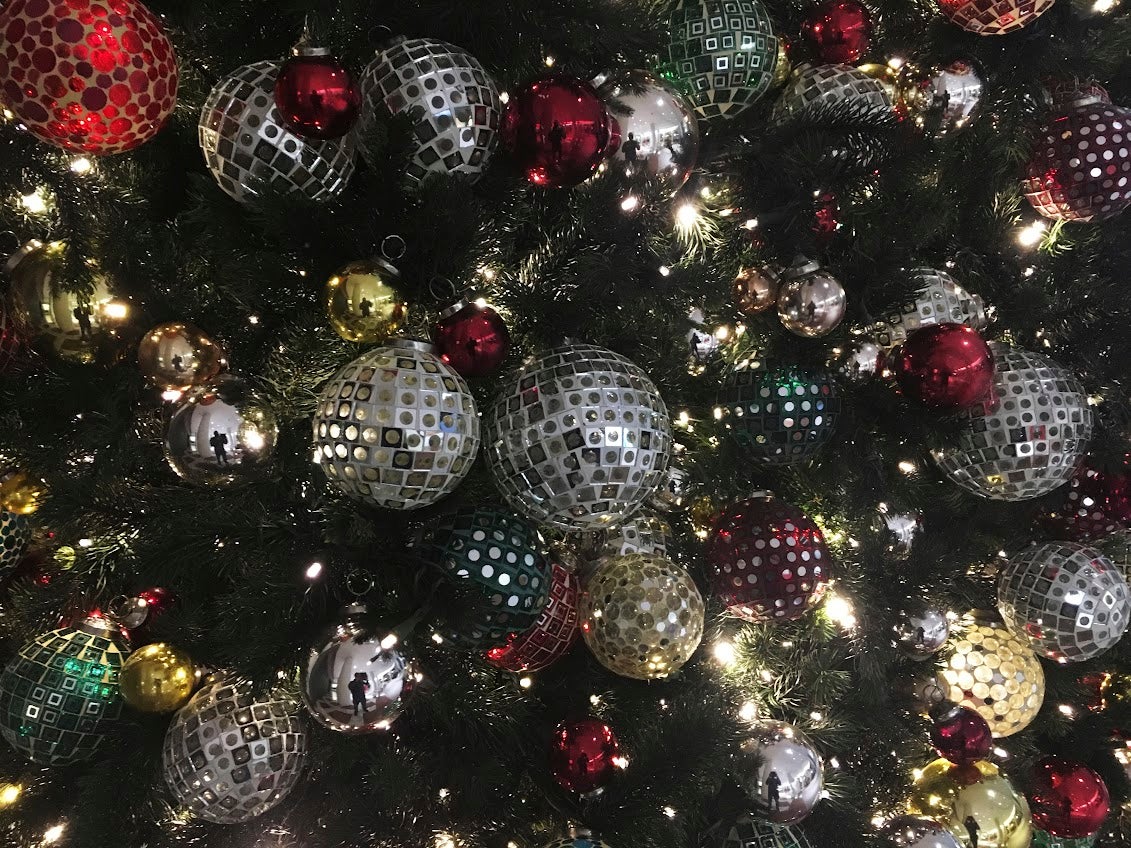 ornaments hang on a Christmas tree