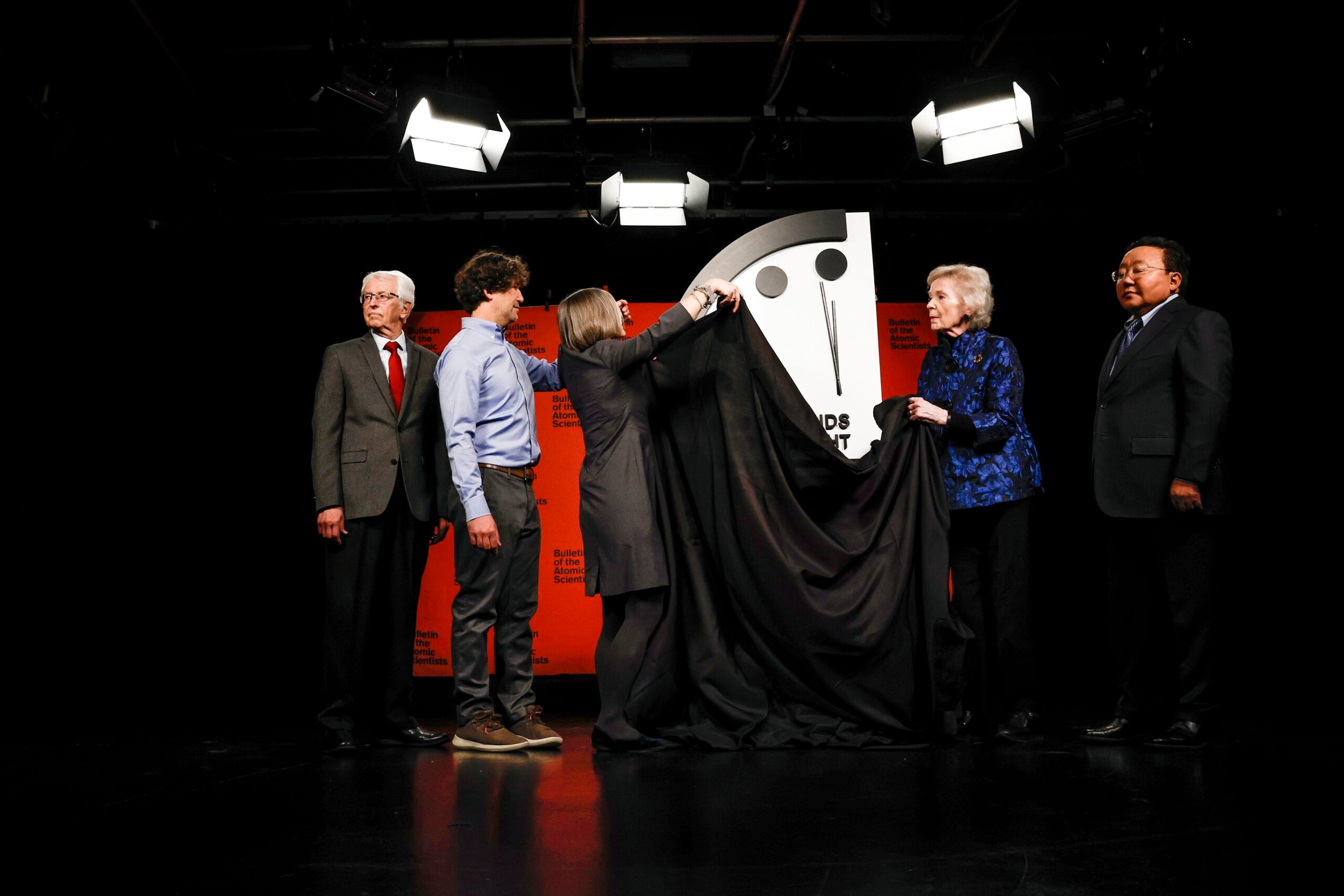 alt = Members of the Bulletin of the Atomic Scientists Siegfried S. Hecker, Daniel Holz, Sharon Squassoni, Mary Robinson and Elbegorj Tsakhia demonstrate unveiling of the 2023 Doomsday Clock ahead of a live-streamed event on January 24, 2023 in Washington, DC.