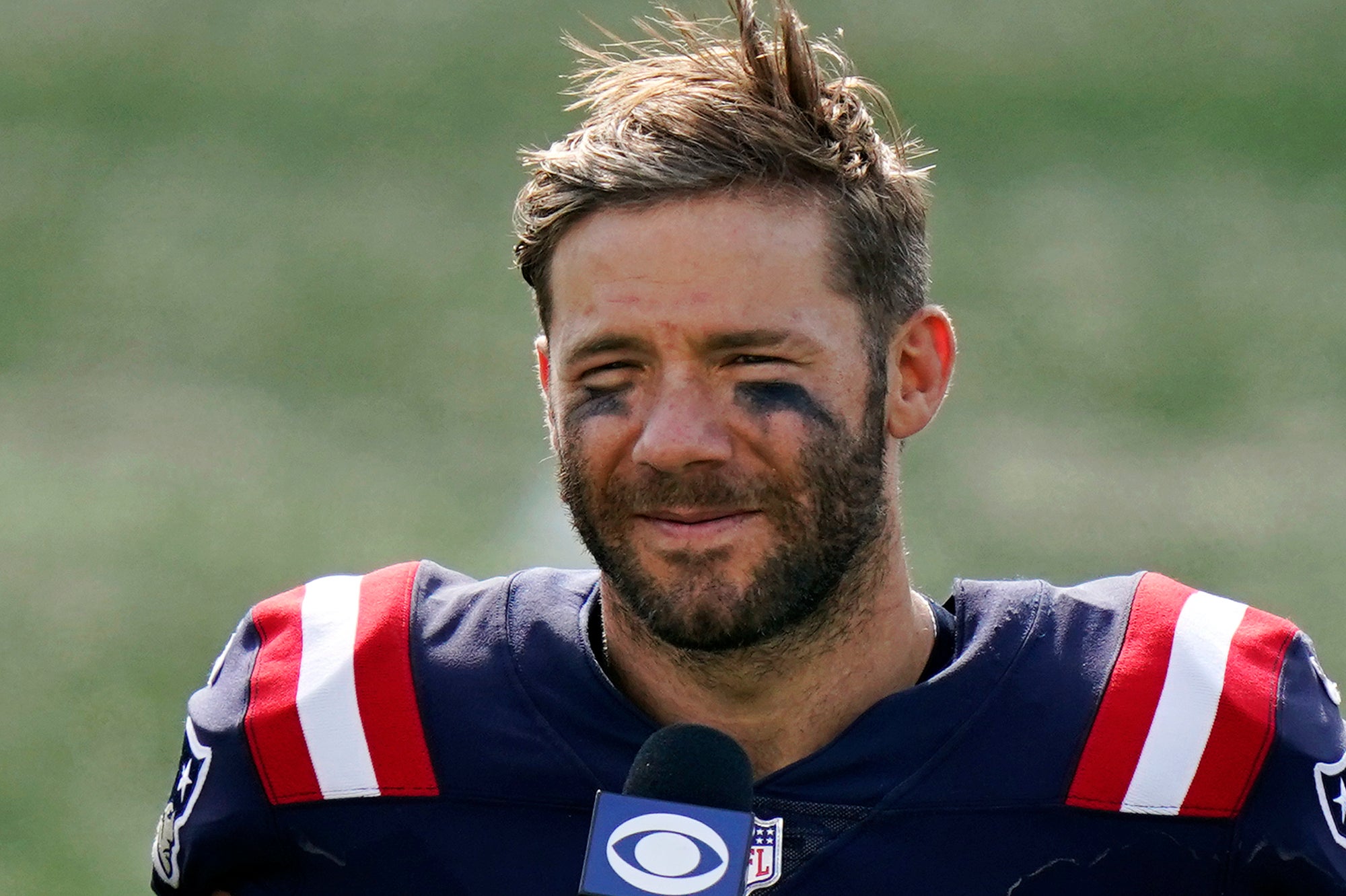 In this Sunday, Sept. 13, 2020 file photo New England Patriots wide receiver Julian Edelman gives a post-game interview after an NFL football game against the Miami Dolphins, in Foxborough, Mass.