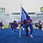 Buffalo Bills running back Taiwan Jones (25) kneels in prayer for safety Damar Hamlin before an NFL football game against the New England Patriots, Sunday, Jan. 8, 2023, in Orchard Park, N.Y. Hamlin remains hospitalized after suffering a catastrophic on-field collapse in the team's previous game against the Cincinnati Bengals.