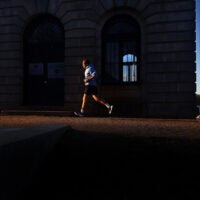 Runners pass a pump house as they loop around the Cleveland Circle Reservoir.