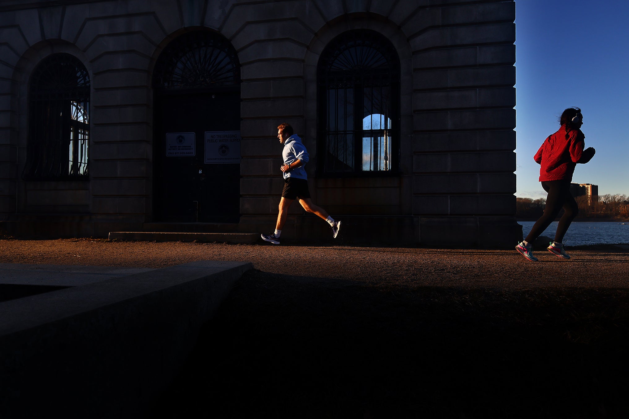 Runners pass a pump house as they loop around the Cleveland Circle Reservoir.