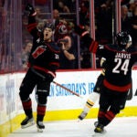 Carolina's Sebastian Aho celebrates with teammate Seth Jarvis after scoring during the first period.