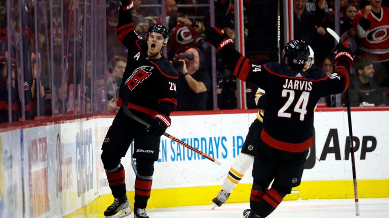Carolina's Sebastian Aho celebrates with teammate Seth Jarvis after scoring during the first period.