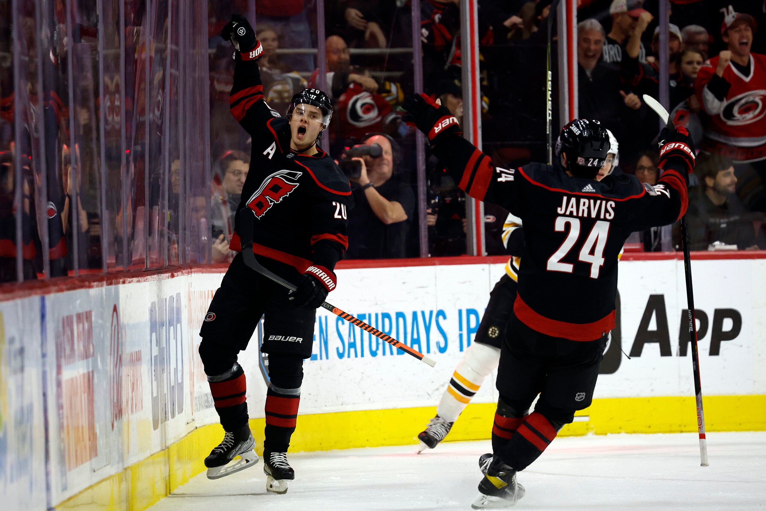 Carolina's Sebastian Aho celebrates with teammate Seth Jarvis after scoring during the first period.