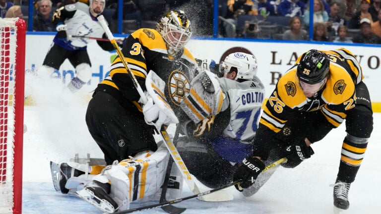 Tampa Bay Lightning center Ross Colton (79) crashes into Boston Bruins goaltender Linus Ullmark (35) after a scheme by defenseman Brandon Carlo (25) during the second period of an NHL hockey game Thursday, Jan. 26, 2023, in Tampa, Fla.