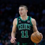Boston Celtics guard Payton Pritchard brings the ball up court during the second half of an NBA basketball game against the Charlotte Hornets in Charlotte, N.C., Monday, Jan. 16, 2023.