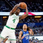 Boston Celtics' Noah Vonleh (4) grabs a rebound in front of Orlando Magic's Cole Anthony (50) during the first half of an NBA basketball game, Saturday, Oct. 22, 2022, in Orlando, Fla.