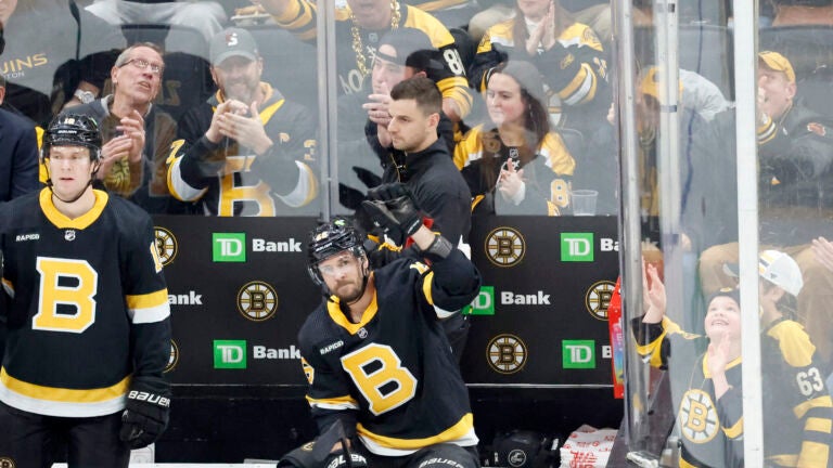 Boston Bruins center David Krejci, right, reacts as he is recognized for playing in his 1000th career game for the Boston Bruins in the first period of an NHL hockey game against the Philadelphia Flyers, Monday, Jan. 16, 2023, in Boston.