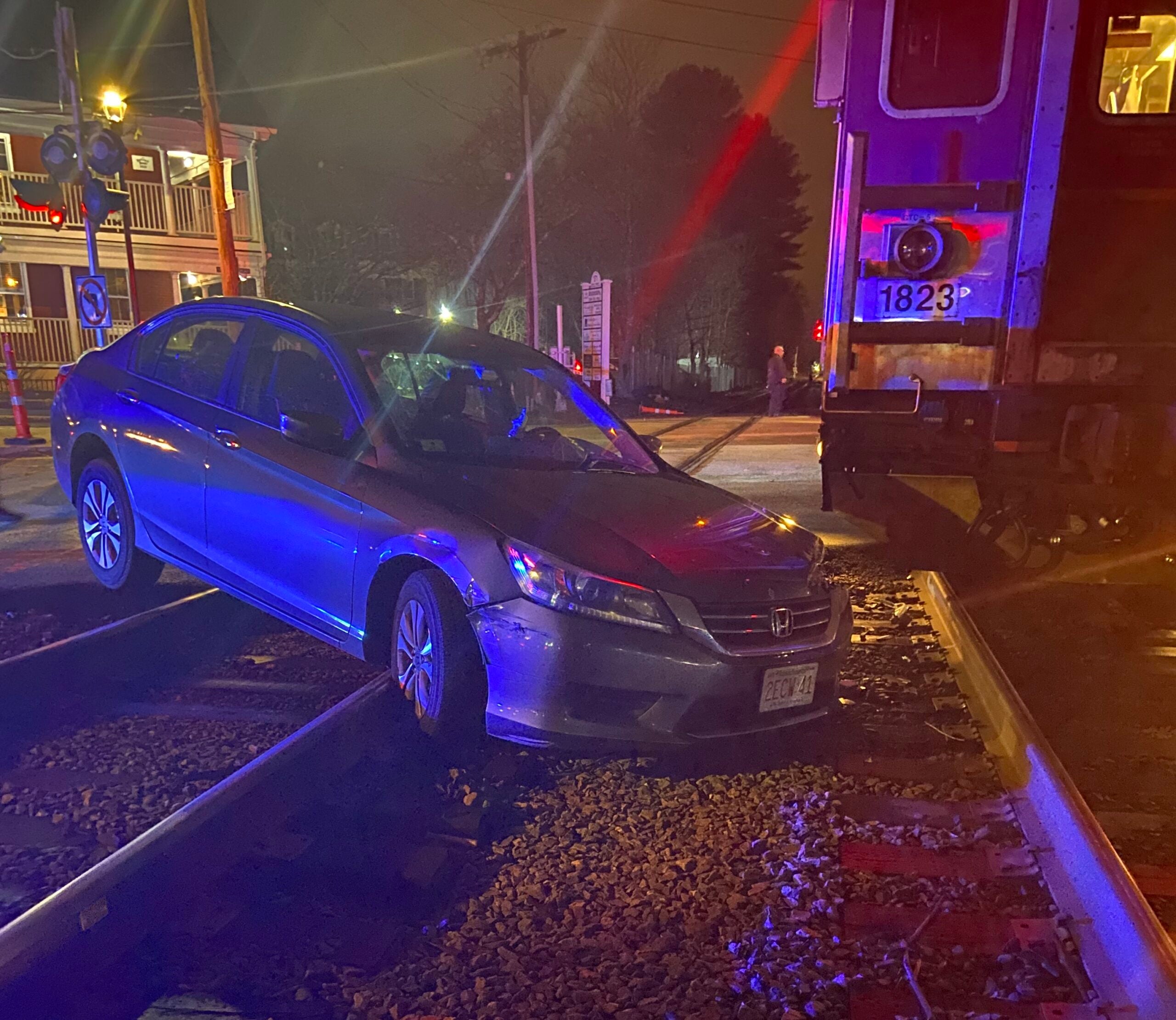 What should you do if you're in a car stuck on train tracks?