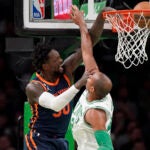 Knicks forward Julius Randle drives to the basket to score as Al Horford defends during the first half.