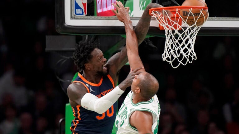 Knicks forward Julius Randle drives to the basket to score as Al Horford defends during the first half.