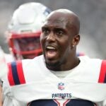Safety Devin McCourty #32 of the New England Patriots speaks to his teammates during warm-up before a preseason game against the Las Vegas Raiders at Allegiant Stadium on August 26, 2022 in Las Vegas, Nevada.