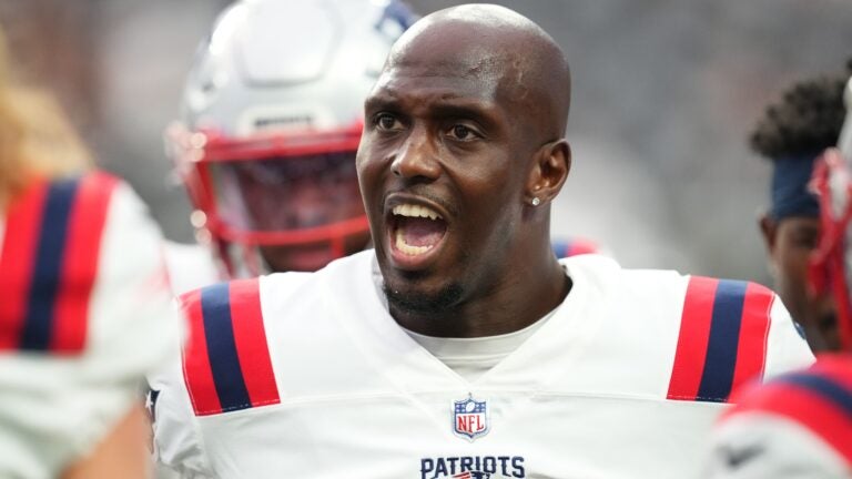 Safety Devin McCourty #32 of the New England Patriots speaks to his teammates during warm-up before a preseason game against the Las Vegas Raiders at Allegiant Stadium on August 26, 2022 in Las Vegas, Nevada.