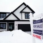 A sign announcing a pending sale is shown in front of a house, Monday, Jan. 23, 2023, in Brooklyn Park, Minn. On Thursday, Freddie Mac reports on this week's average U.S. mortgage rates.