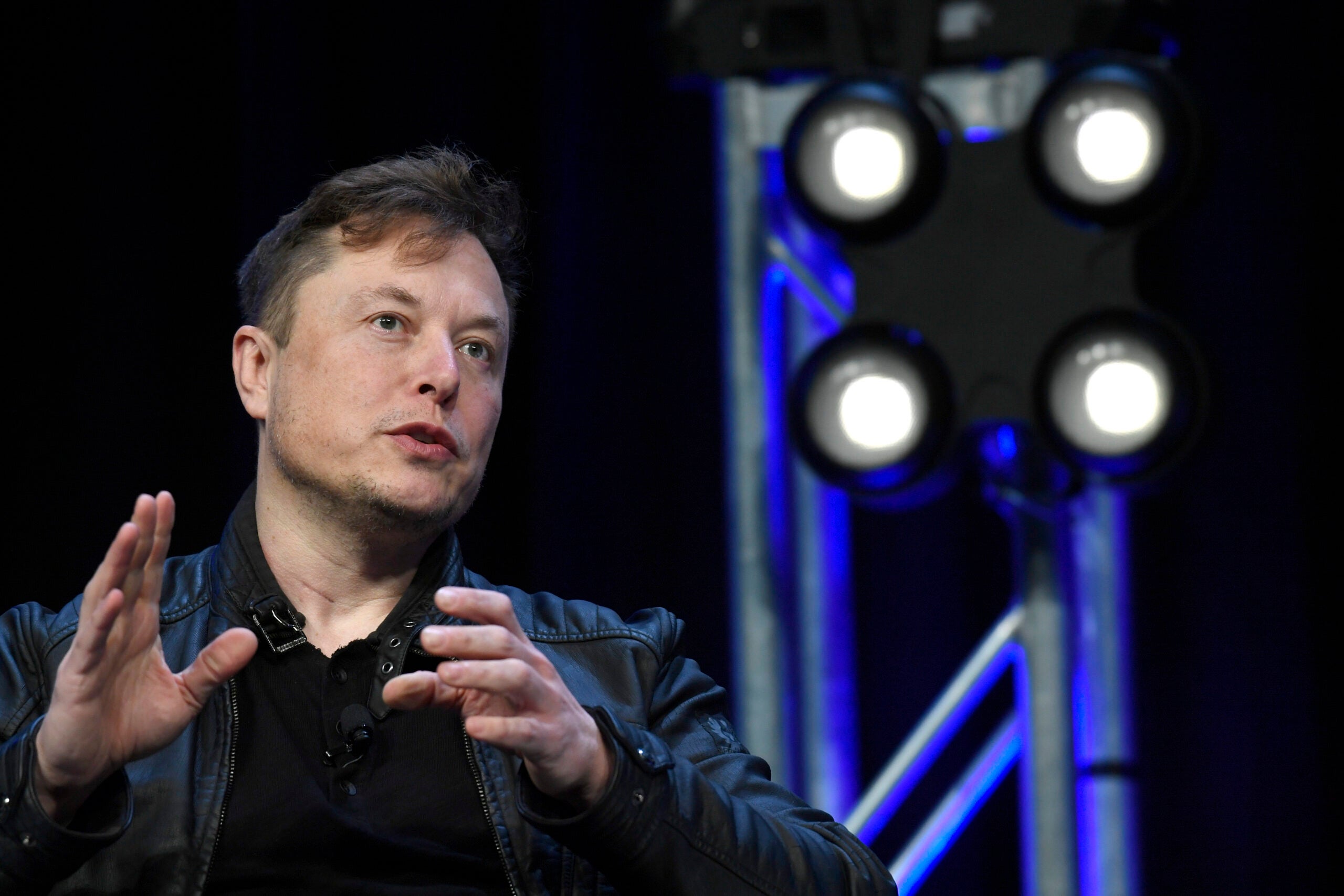 alt = Tesla and SpaceX Chief Executive Officer Elon Musk speaks at the SATELLITE Conference and Exhibition in Washington