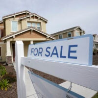 A "for sale" sign is posted in front of a home in Sacramento, Calif., in March. Buyers have been waiving home inspections to make their offers more attractive to sellers.