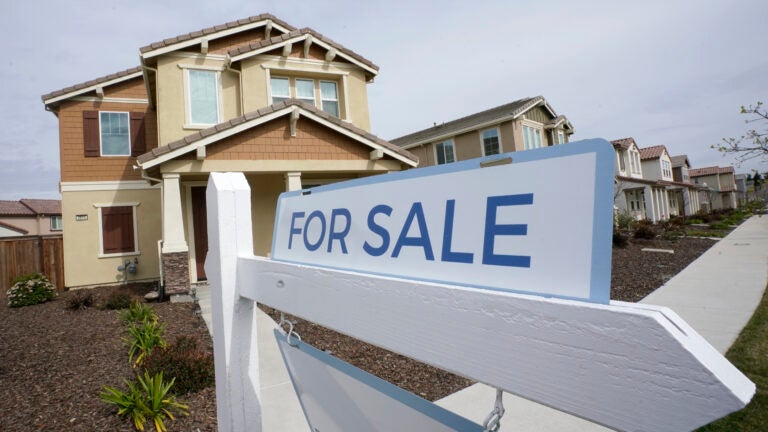A "for sale" sign is posted in front of a home in Sacramento, Calif., in March. Buyers have been waiving home inspections to make their offers more attractive to sellers.