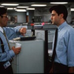 A disgruntled computer programmer named Peter, played by Ron Livingston (right) endures another lecture by his boss, played by Gary Cole, in this scene from the 1999 movie "Office Space."