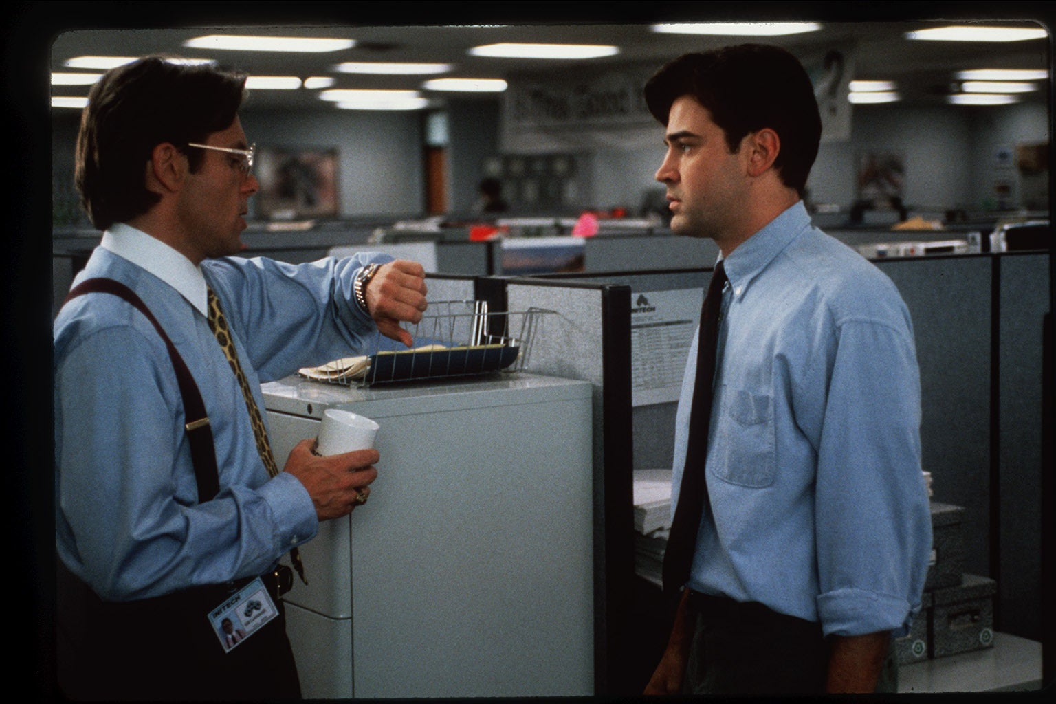 A disgruntled computer programmer named Peter, played by Ron Livingston (right) endures another lecture by his boss, played by Gary Cole, in this scene from the 1999 movie "Office Space."
