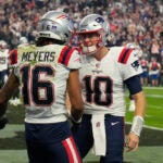 New England Patriots wide receiver Jakobi Meyers (16) celebrates with quarterback Mac Jones (10) after scoring a touchdown against the Las Vegas Raiders during the first half of an NFL football game, Sunday, Dec. 18, 2022, in Las Vegas.