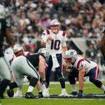 New England Patriots quarterback Mac Jones (10) calls a play during an NFL football game against the Las Vegas Raiders Monday, Aug. 29, 2022, in Las Vegas, Nevada.