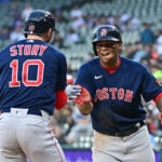 Trevor Story #10 and Rafael Devers #11 of the Boston Red Sox celebrate the three run home run in the first inning against the Chicago White Sox at Guaranteed Rate Field on May 24, 2022 in Chicago, Illinois.