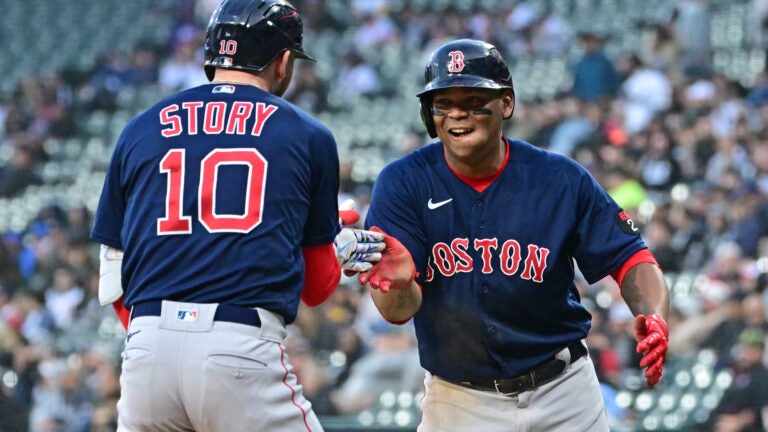 Trevor Story #10 and Rafael Devers #11 of the Boston Red Sox celebrate the three run home run in the first inning against the Chicago White Sox at Guaranteed Rate Field on May 24, 2022 in Chicago, Illinois.