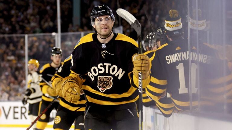 Jake DeBrusk #74 of the Boston Bruins celebrates with teammates after scoring a goal against the Pittsburgh Penguins during the third period in the 2023 Discover NHL Winter Classic at Fenway Park on January 02, 2023 in Boston, Massachusetts.