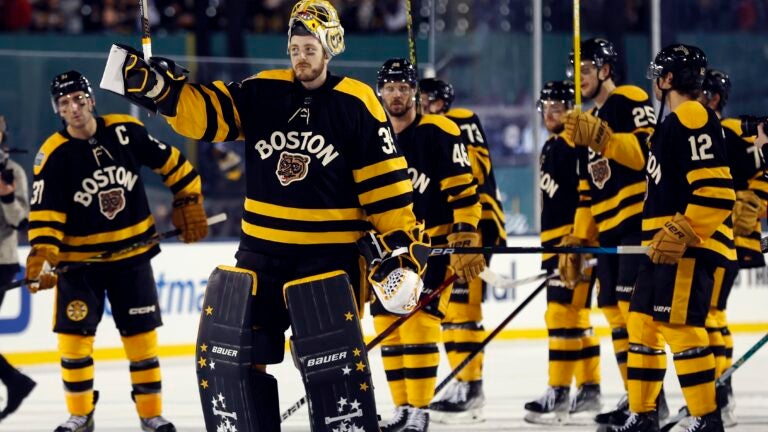 Boston Bruins' Linus Ullmark (35) and teammates celebrate after defeating the Pittsburgh Penguins in the NHL Winter Classic hockey game, Monday, Jan. 2, 2023, at Fenway Park in Boston.