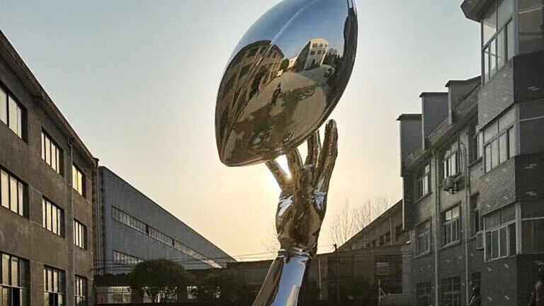 “Opportunity (reflection)” by Hank Willis Thomas. Its reflective surface resembles the Vince Lombardi Trophy given to the winning Super Bowl team.