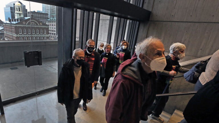Protestors from The New Democracy Coalition are pictured as they climb the stairs to the fifth floor of Boston City Hall
