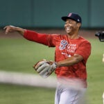 Rafael Devers has a huge smile on his face as he is being shown live on NESN throwing during a 2020 workout.