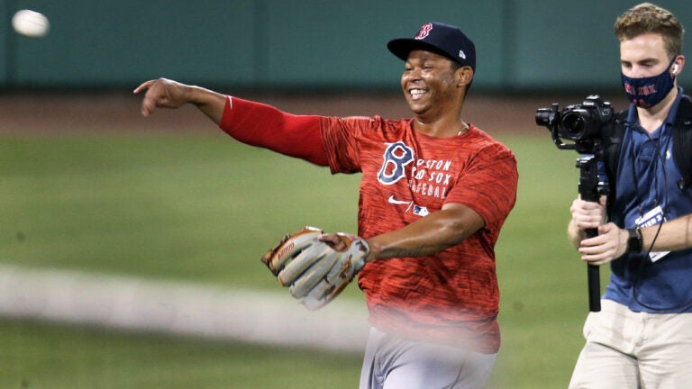 Rafael Devers has a huge smile on his face as he is being shown live on NESN throwing during a 2020 workout.